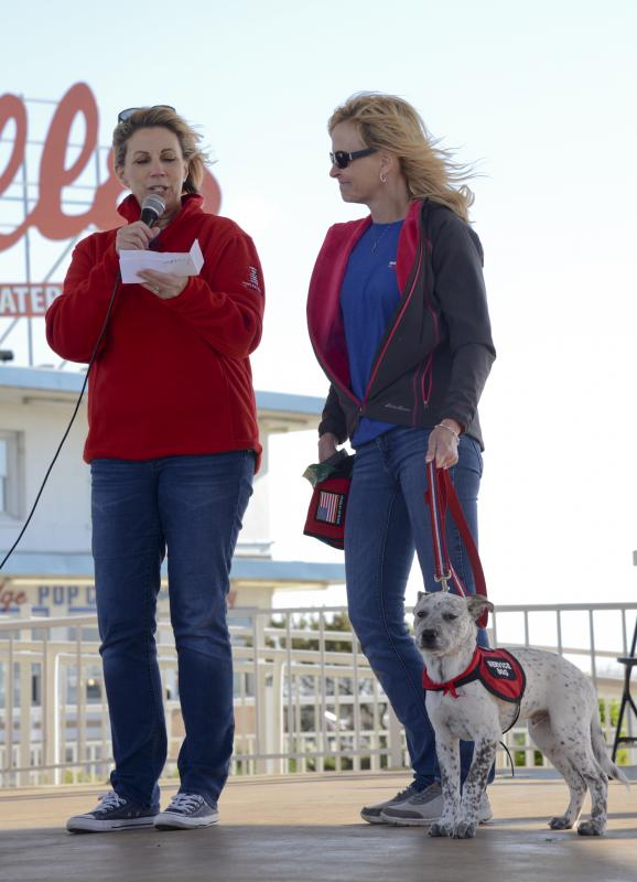 Gold Star mother Karen Vaughn announces Heather Lloyd from Tails of Valor before she knows the service dog with Lloyd will be named Vaughn, after her son.